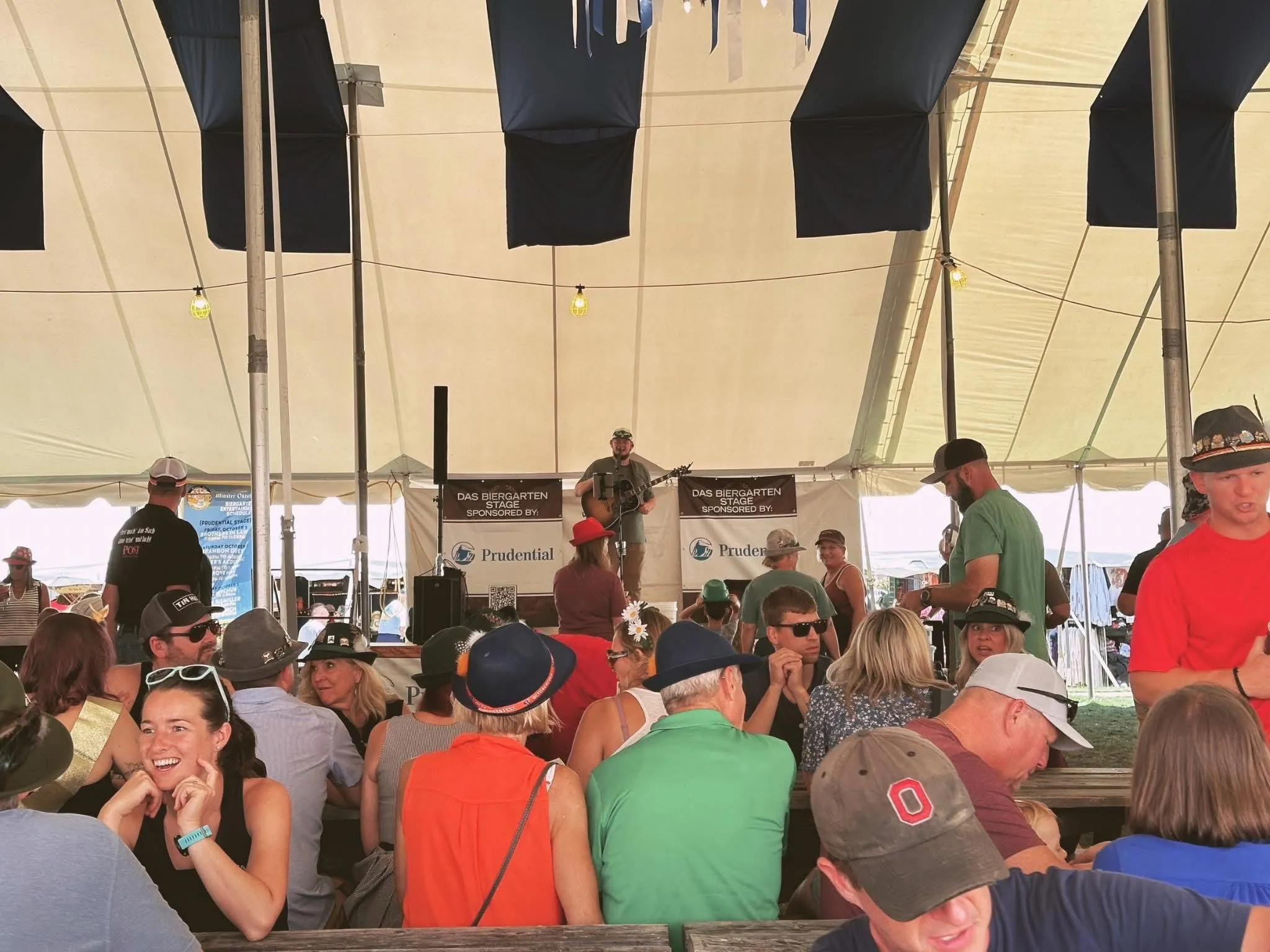 Isaac Buschur playing the Das Biergarten stage under a festival tent