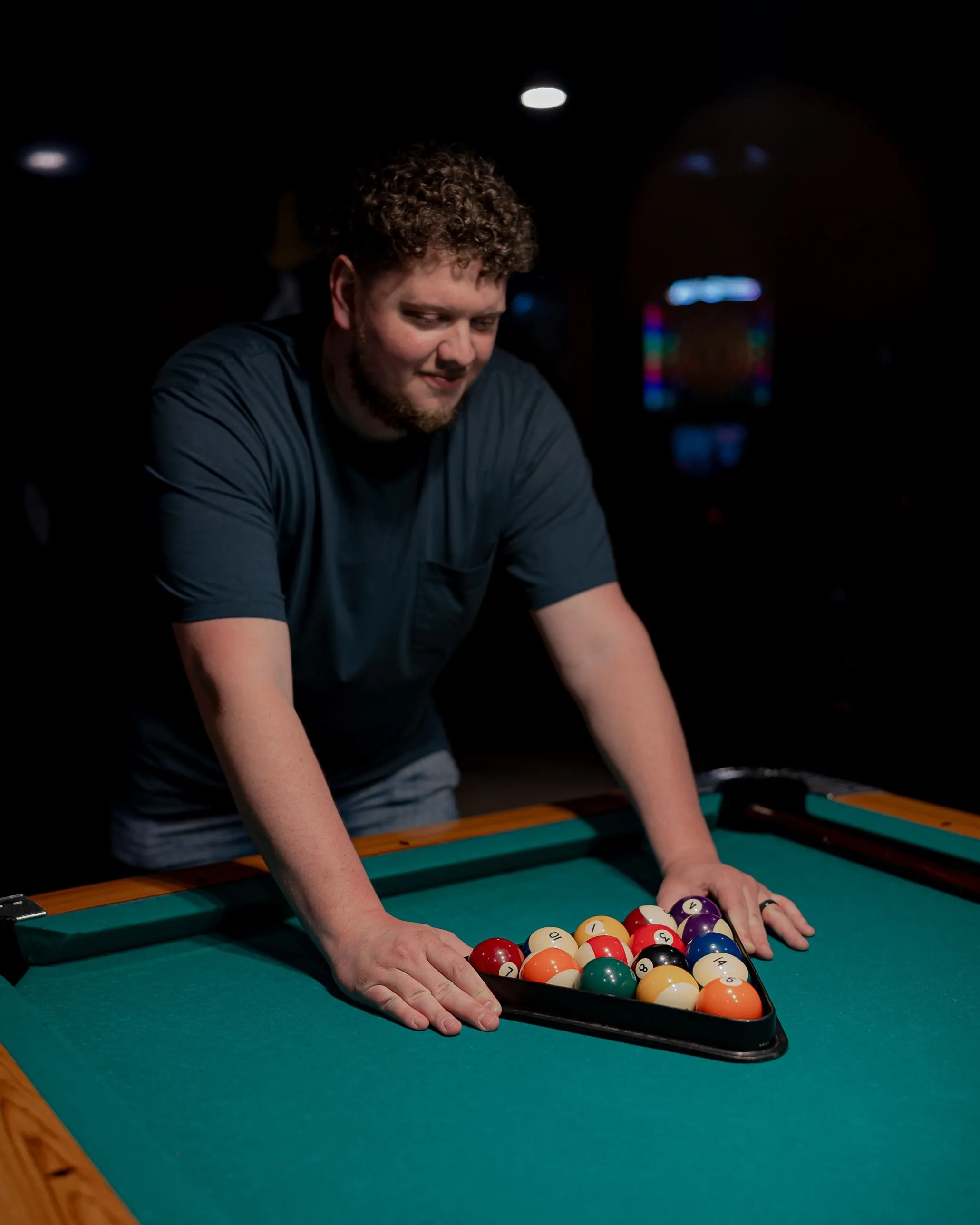 Isaac Buschur racking pool balls